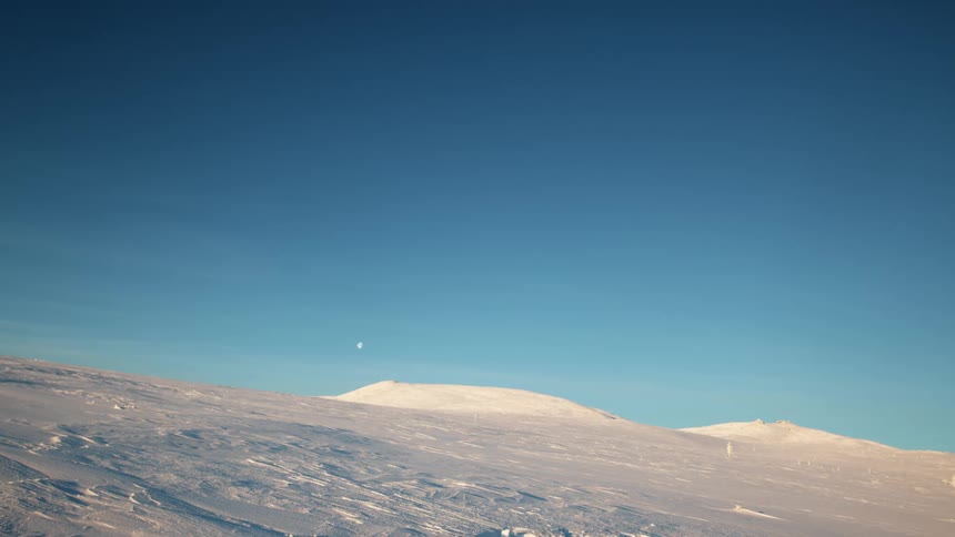 A landscape with snow and ice with the sky and clouds in the background