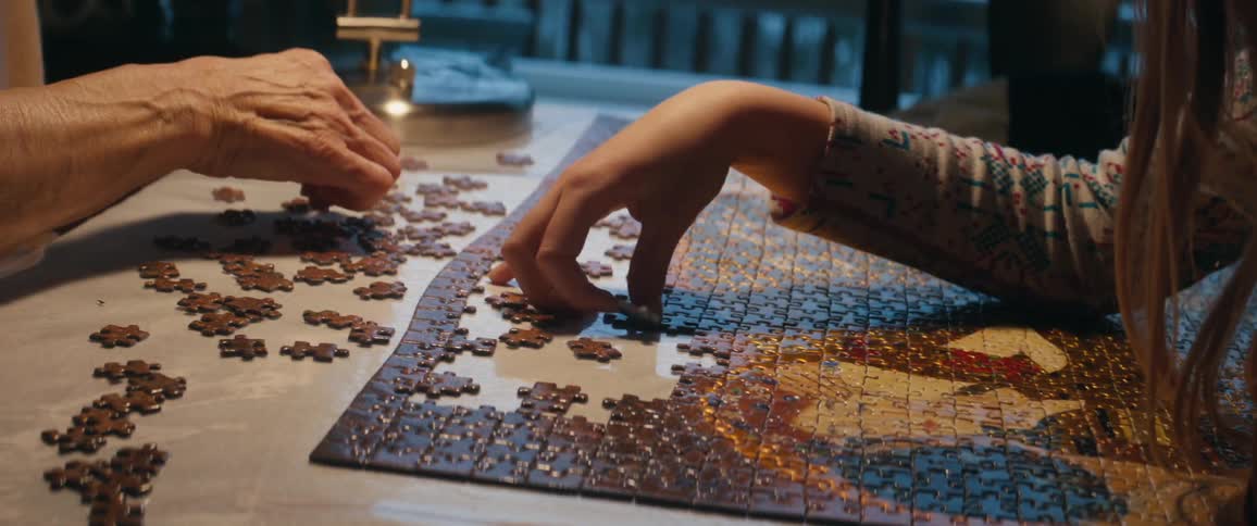 Three people working on a puzzle together