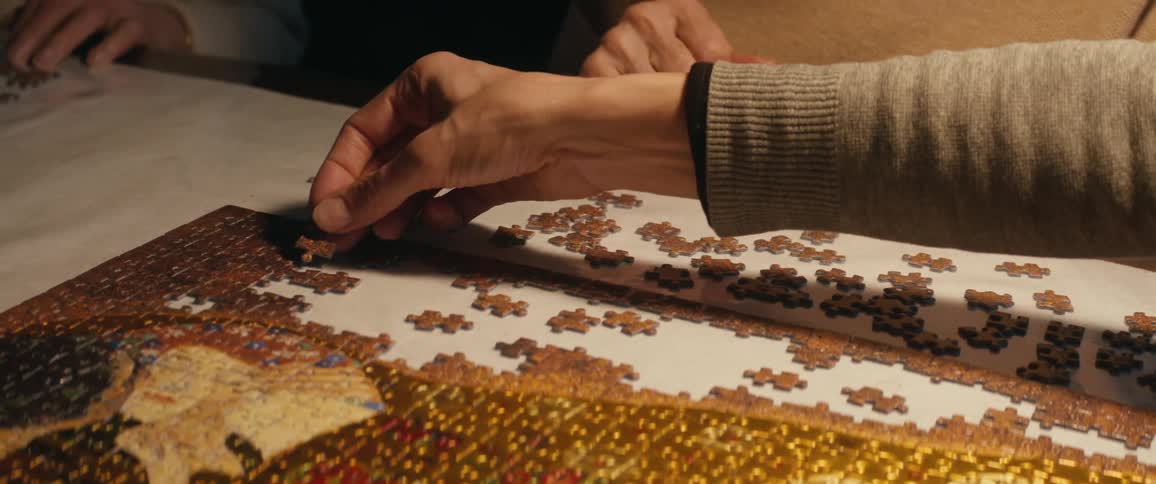 Three people working on a puzzle