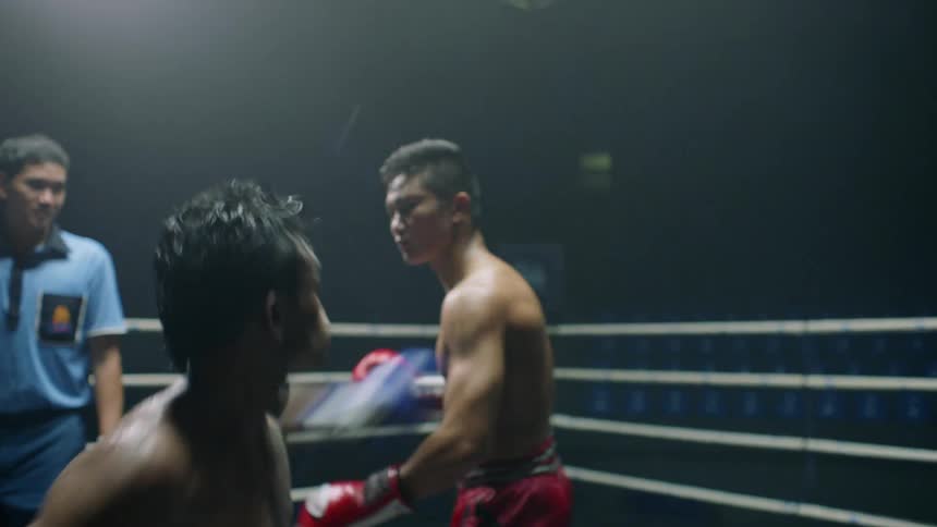 A fighter is struck in a boxing and throws a punch that knocks his competitor back