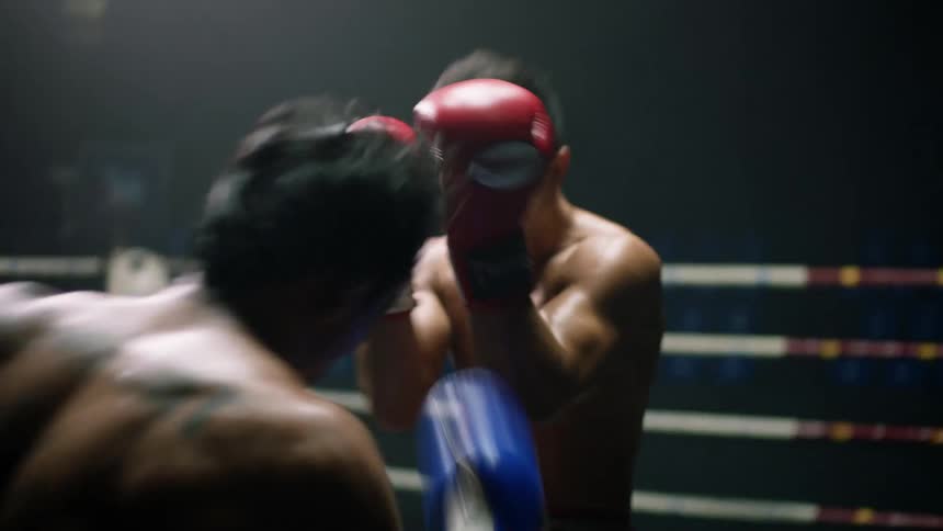 Two heavily tattooed fighters battle in a boxing ring