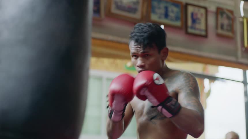 A man throwing punches at a punching bag