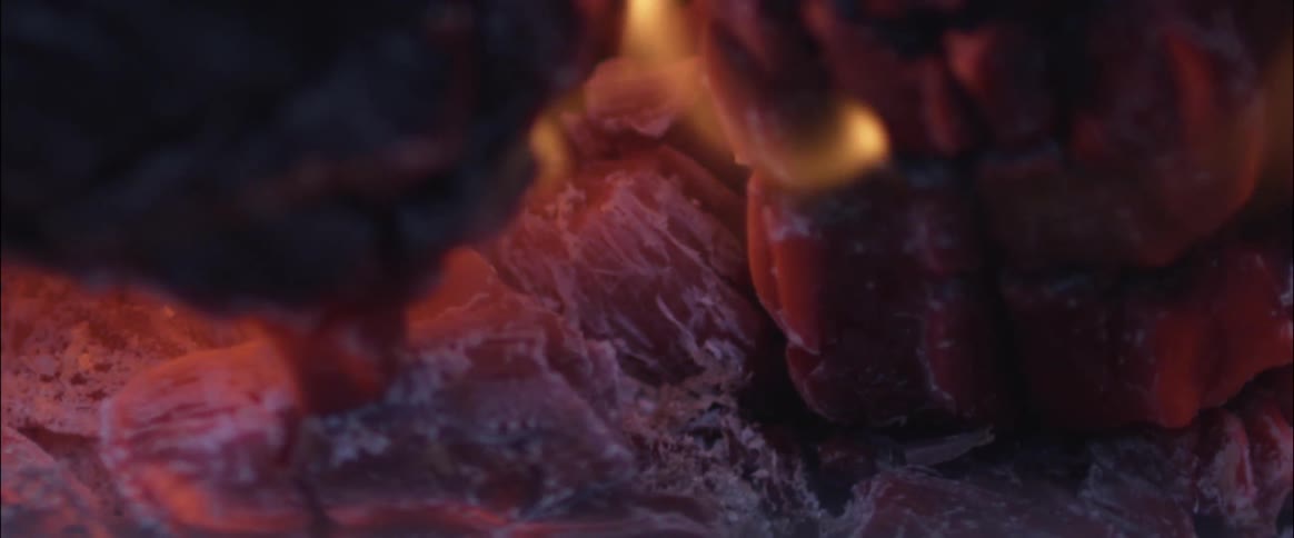Close up of wood logs burning with embers glowing