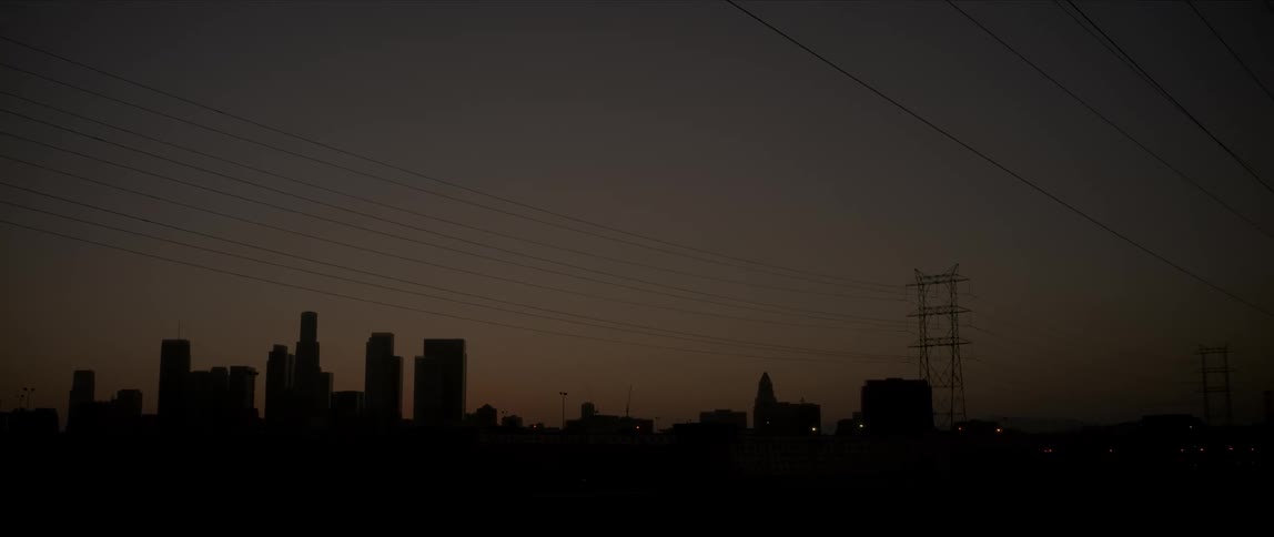 Skyline at night with power lines and dark overlays