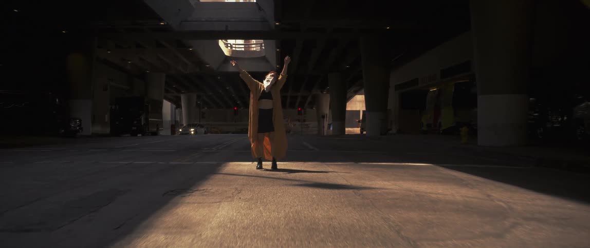A woman is dancing in the middle of a street