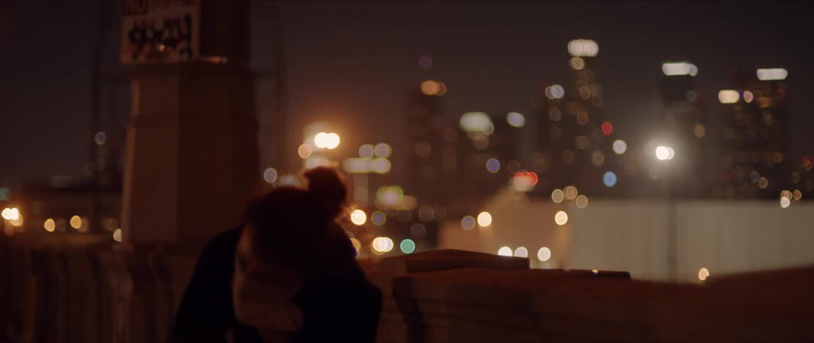 A person standing near a skyline moving