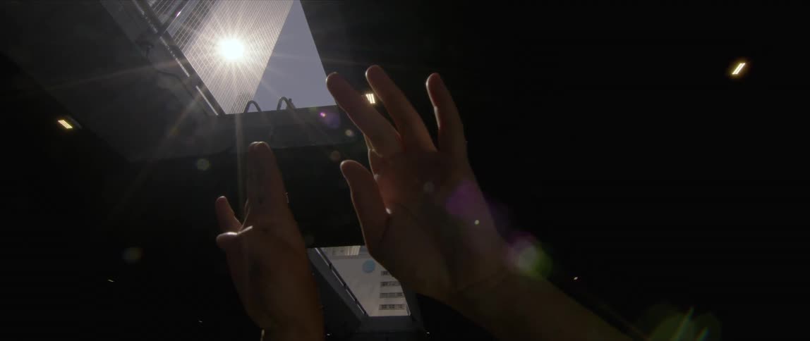 A woman waves her hands as she dances in a parking garage downtown