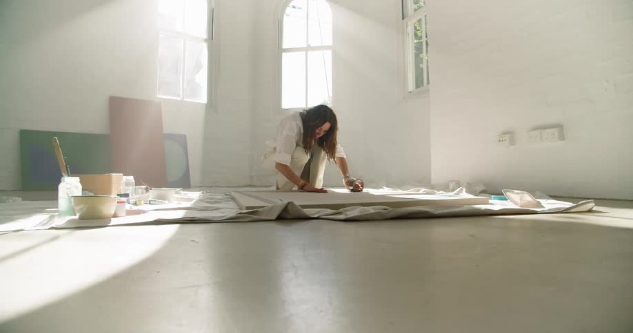 A woman painting on a canvas
