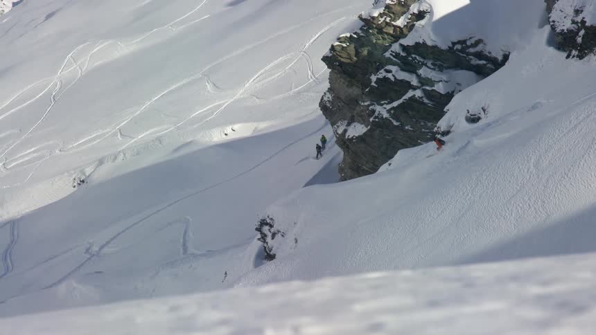 Person is skiing down a snow covered mountain hill