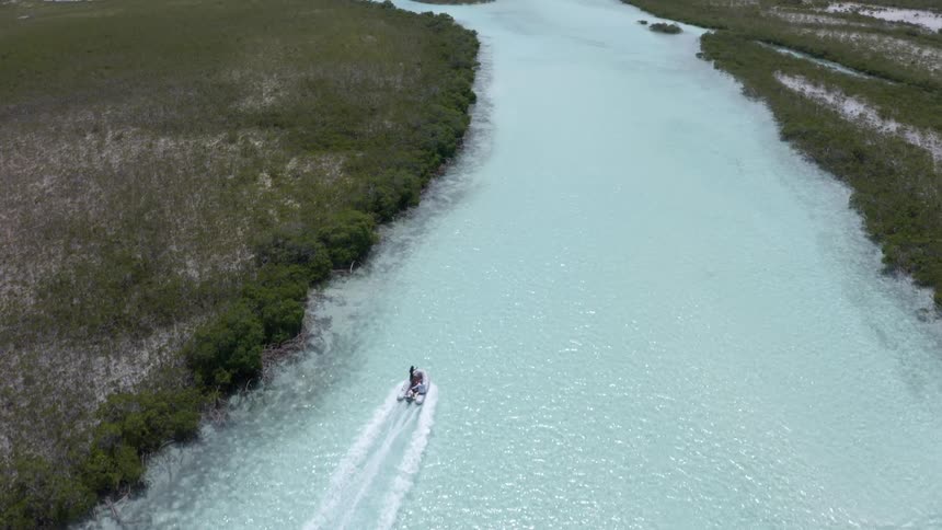 Small boat traveling on the clear waters of a river