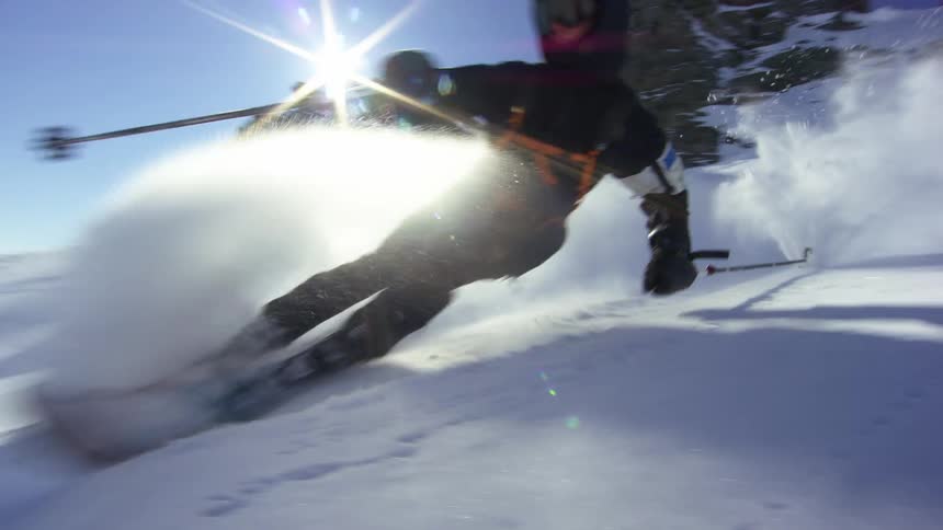 A person is snowboarding down a mountain in winter