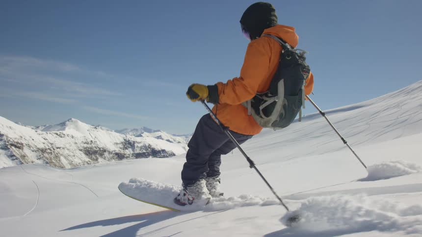 A person is using two poles to ski down a mountain