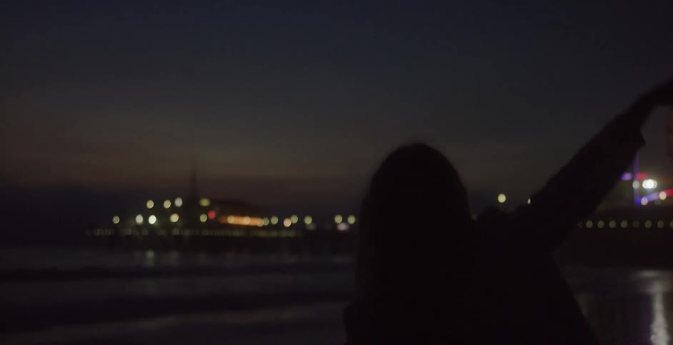 A woman dancing at night