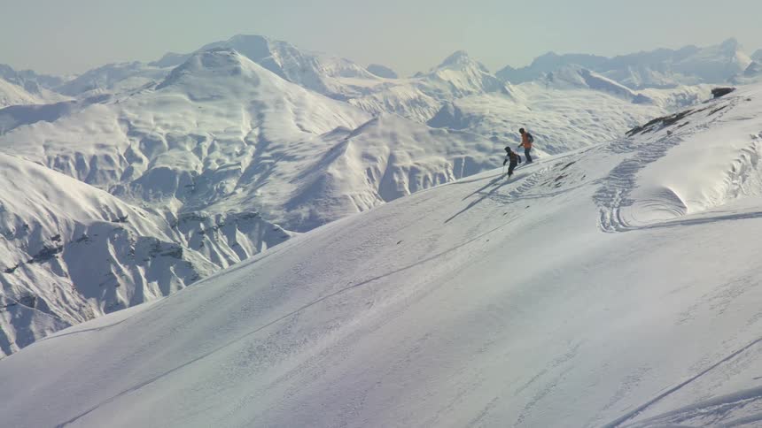 Two people skiing down a mountain
