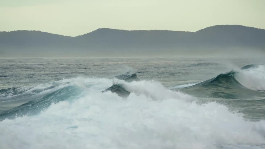 Close up of waves crashing in the middle of the ocean