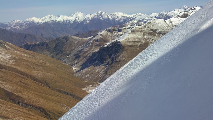 On a big mountain looking out at a landscape of mountains