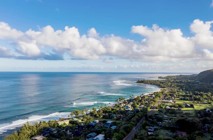 Time lapse of a neighborhood on the shore with waves rolling in to the beach