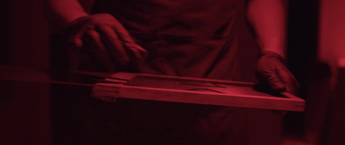A man developing film in a dark room