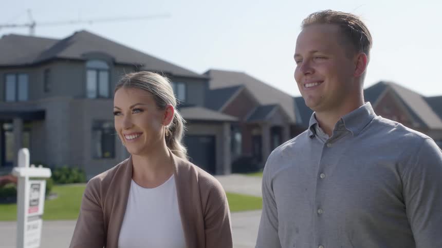 A man and woman looking at a house