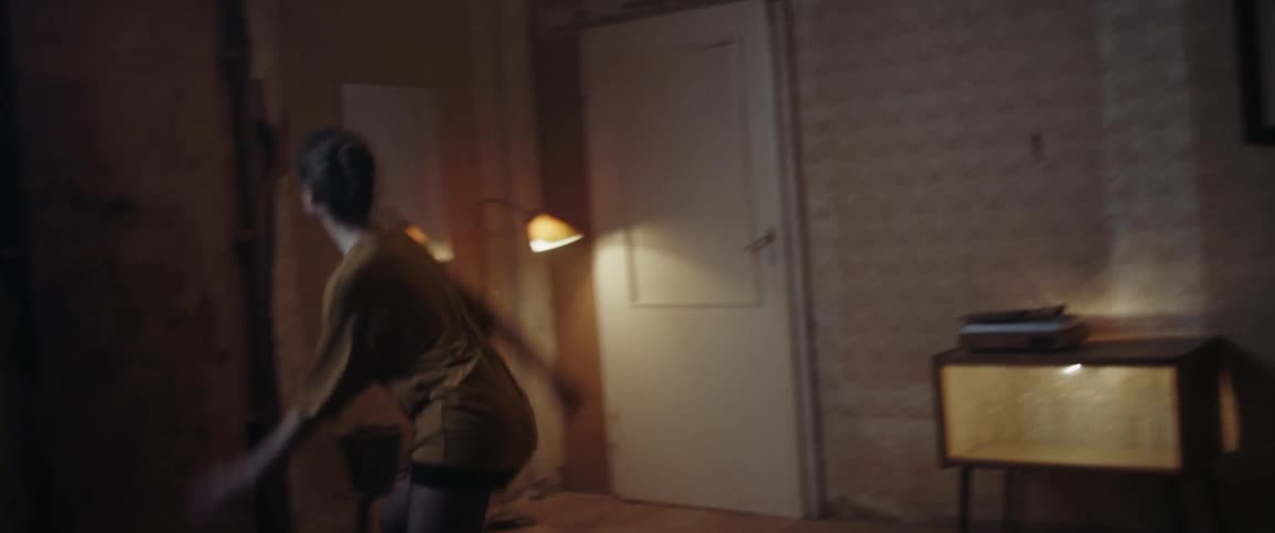 A woman aggressively dancing in a room