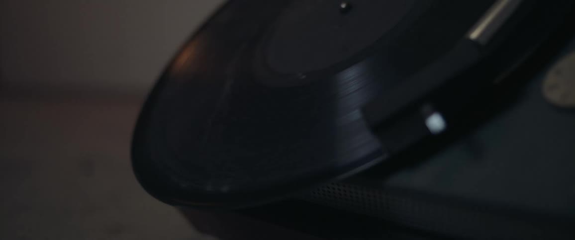 A record player with smudged record playing and flashing light