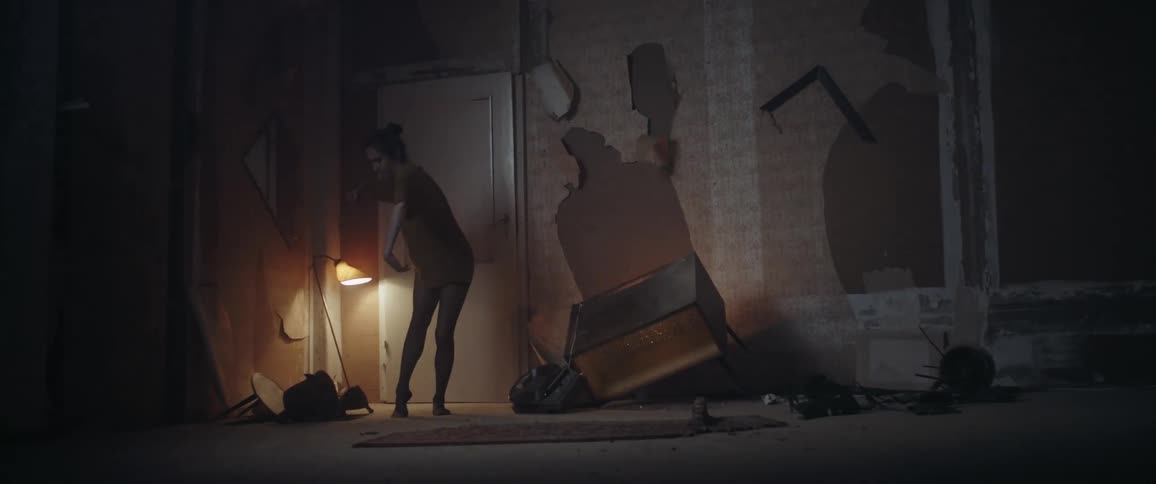 Female dancer dances in room with damaged walls