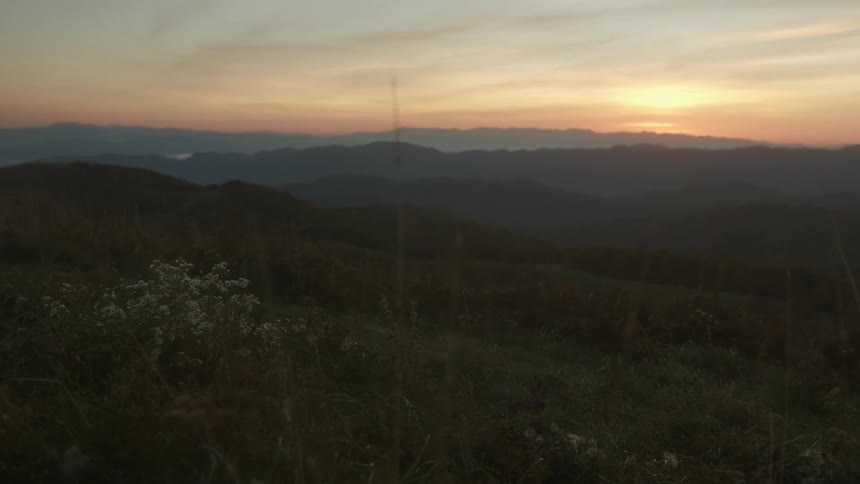 Sunset over mountain range in an orange sky