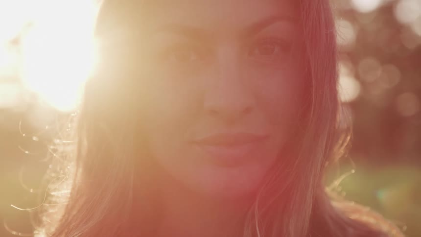 White woman staring at the camera and blinking