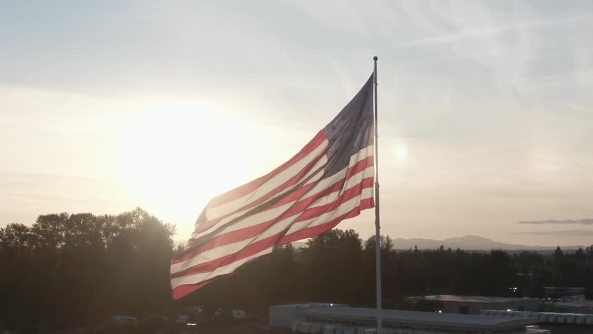 An american flag is waving on a flagpole