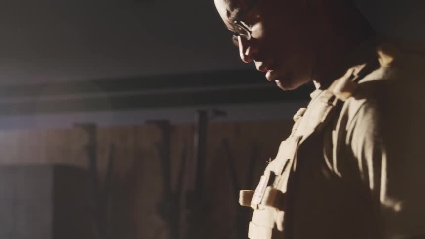 A soldier rocks back and forth in the hall