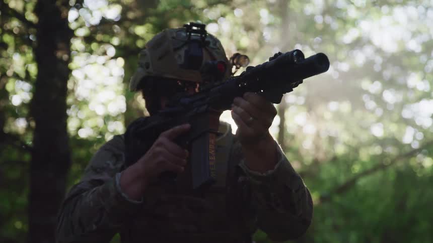 A soldier pointing his gun outside