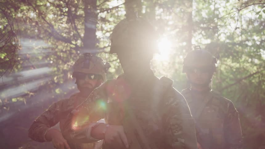 Three soldiers holding weapons standing in a forest