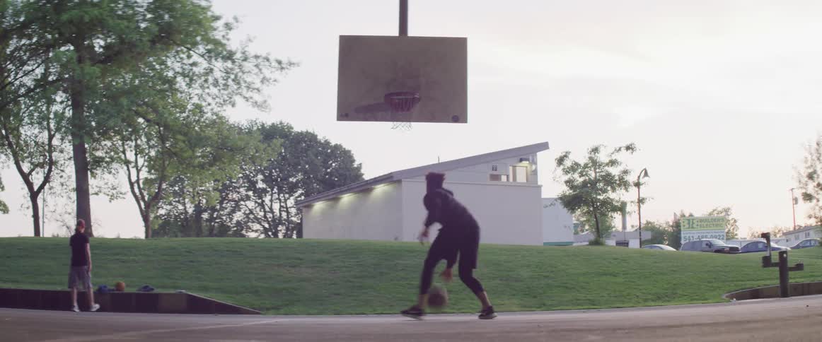 Black man playing basketball alone and scoring a point