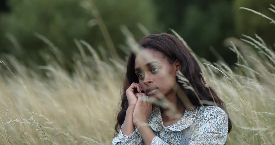 A woman sitting in a field