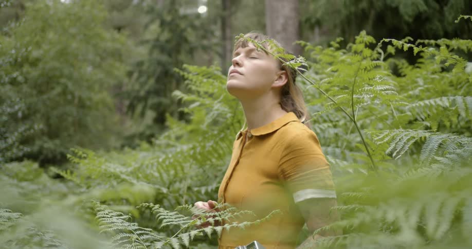 A woman standing in tall plants