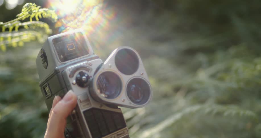 An old camera being focused up in a forest