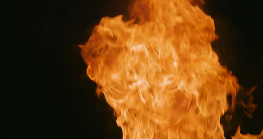 Orange flames rise into the blackness around them