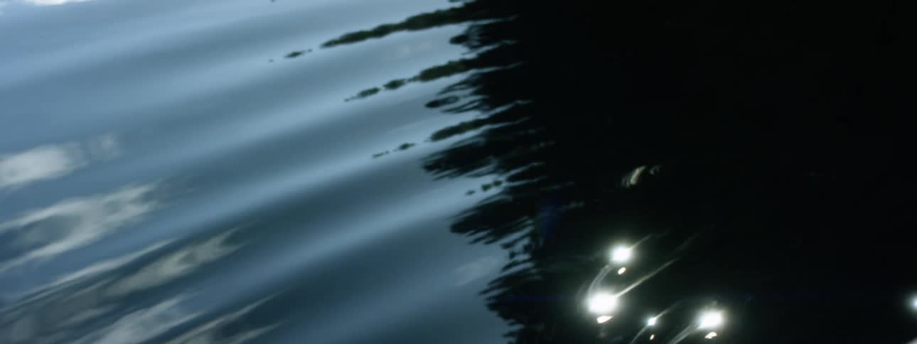 Close up of the ripples on the surface of the water near a boat