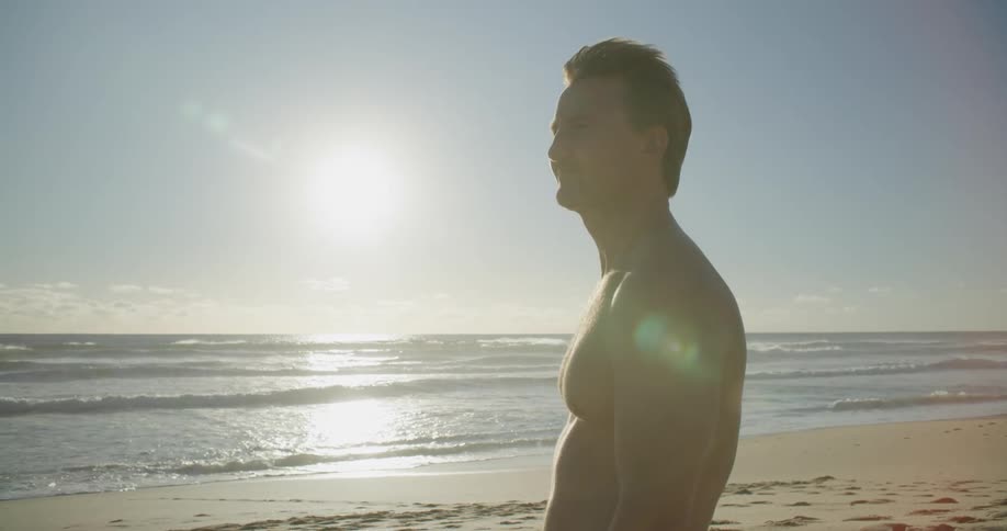 A guy is standing at the beach during spring