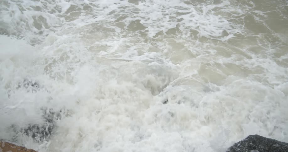 Water rapids rushing over rocks and splashing