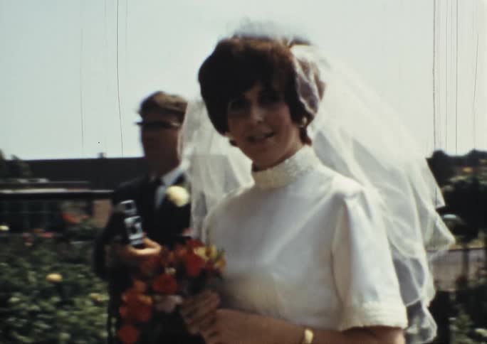 Vintage footage of a bride walking down the aisle with her father
