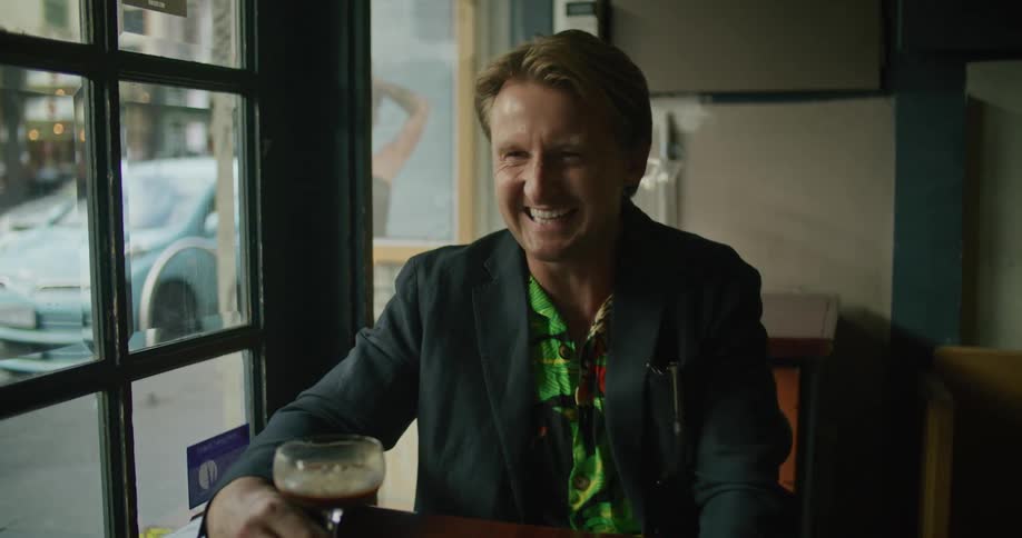 A man sitting in a restaurant and laughing