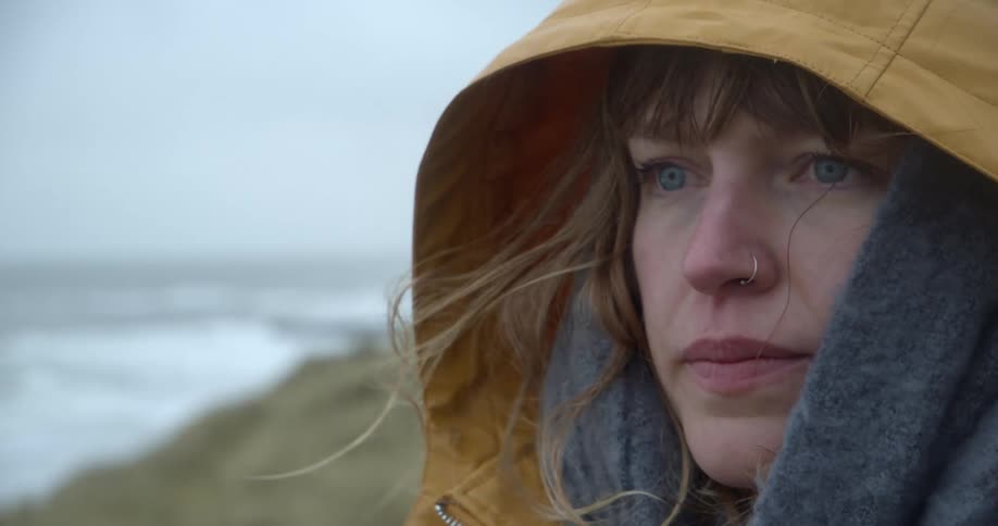 Woman looking to the sea with a sad face