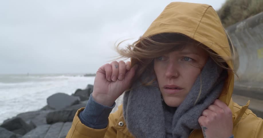 A woman walking down a coast