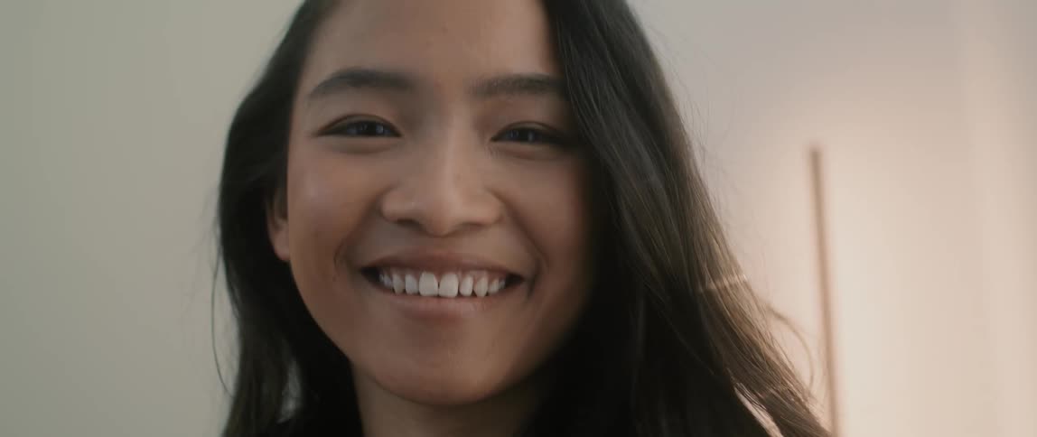 An asian teenage girl is smiling