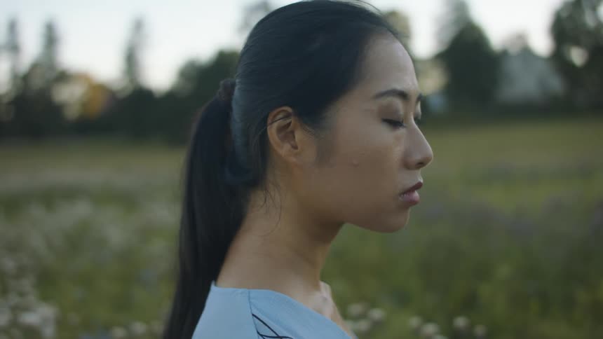 A woman is walking outdoors in spring