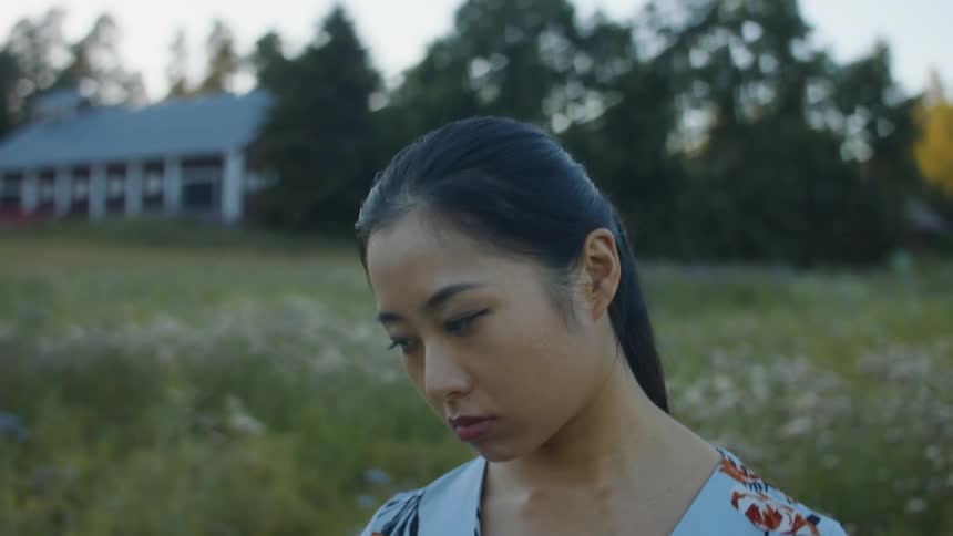 A woman is standing outdoors in spring