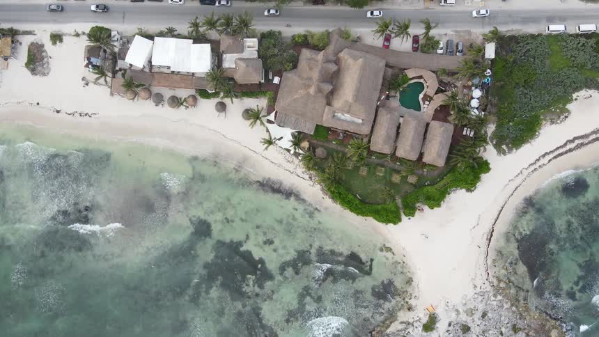 A wide shot of a house by the coast