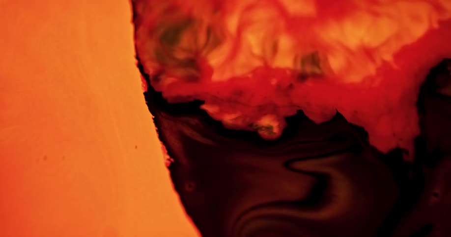Brown red and orange liquids blend and flow