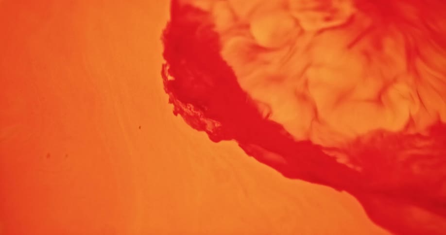 A close up of a liquid shooting into another liquid